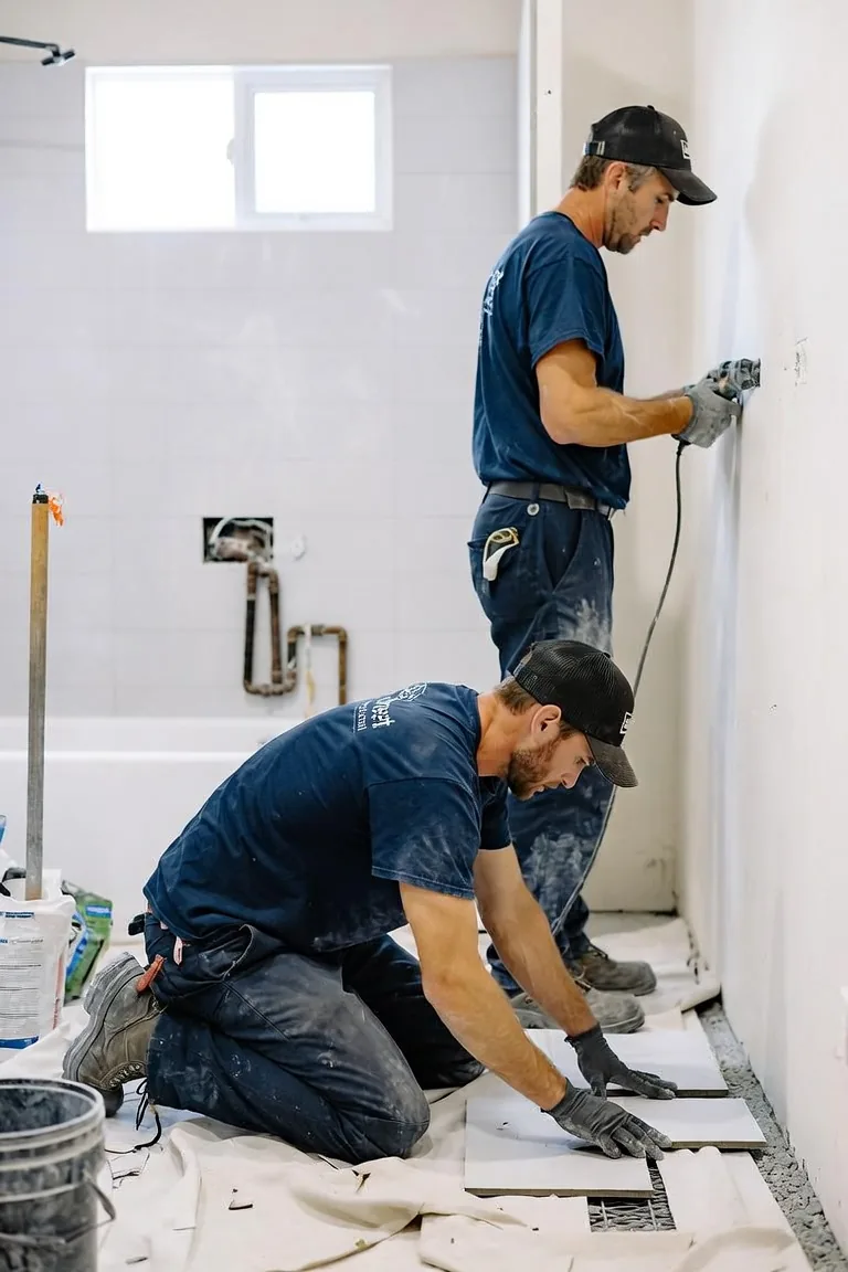 Southeast Commercial Services crew installing floor tile and prepping walls during an Atlanta commercial restroom remodel