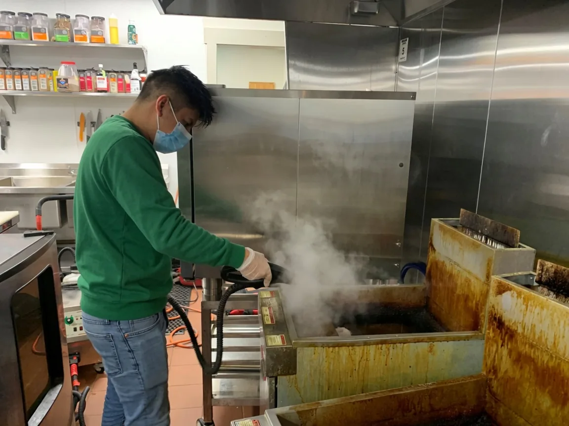 Southeast Commercial Services technician steam cleaning greasy commercial kitchen equipment in Atlanta